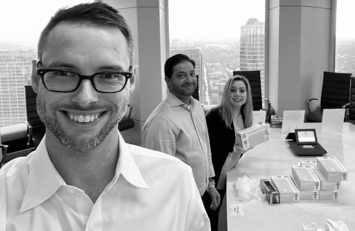 Cole Sanches, Shamil Zuberi and Sol Smiley pose for a selfie while assembling COVID-19 safety kits. 