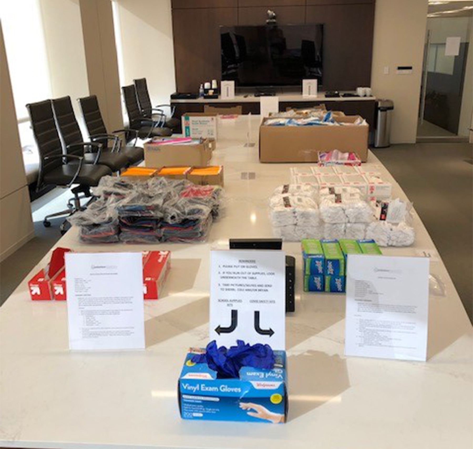 An EnCap conference room served as the volunteer work site for EnCap employees to assemble COVID-19 safety kits and school supply kits.