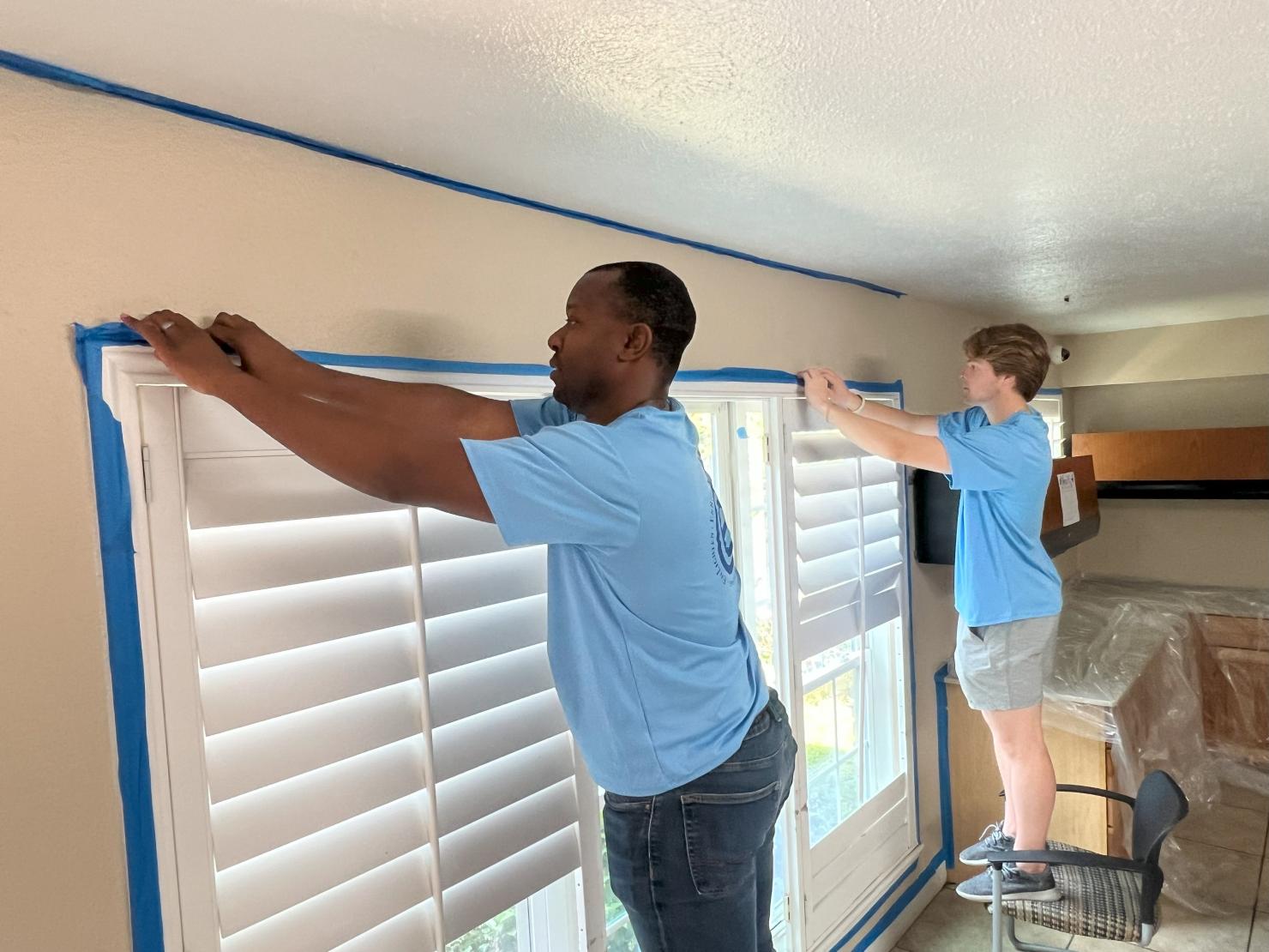 EnCap employees prepare the large activity room to be painted by taping and laying down drop cloths. EnCap employees prepare the large activity room to be painted by taping and laying down drop cloths. 