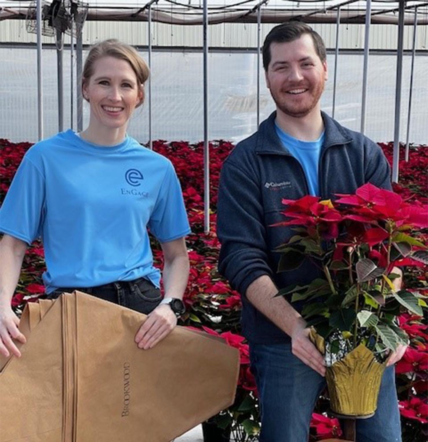 Sarah Freeman (L) and Ben Bryson (R) begin sleeving poinsettias on the gold team.