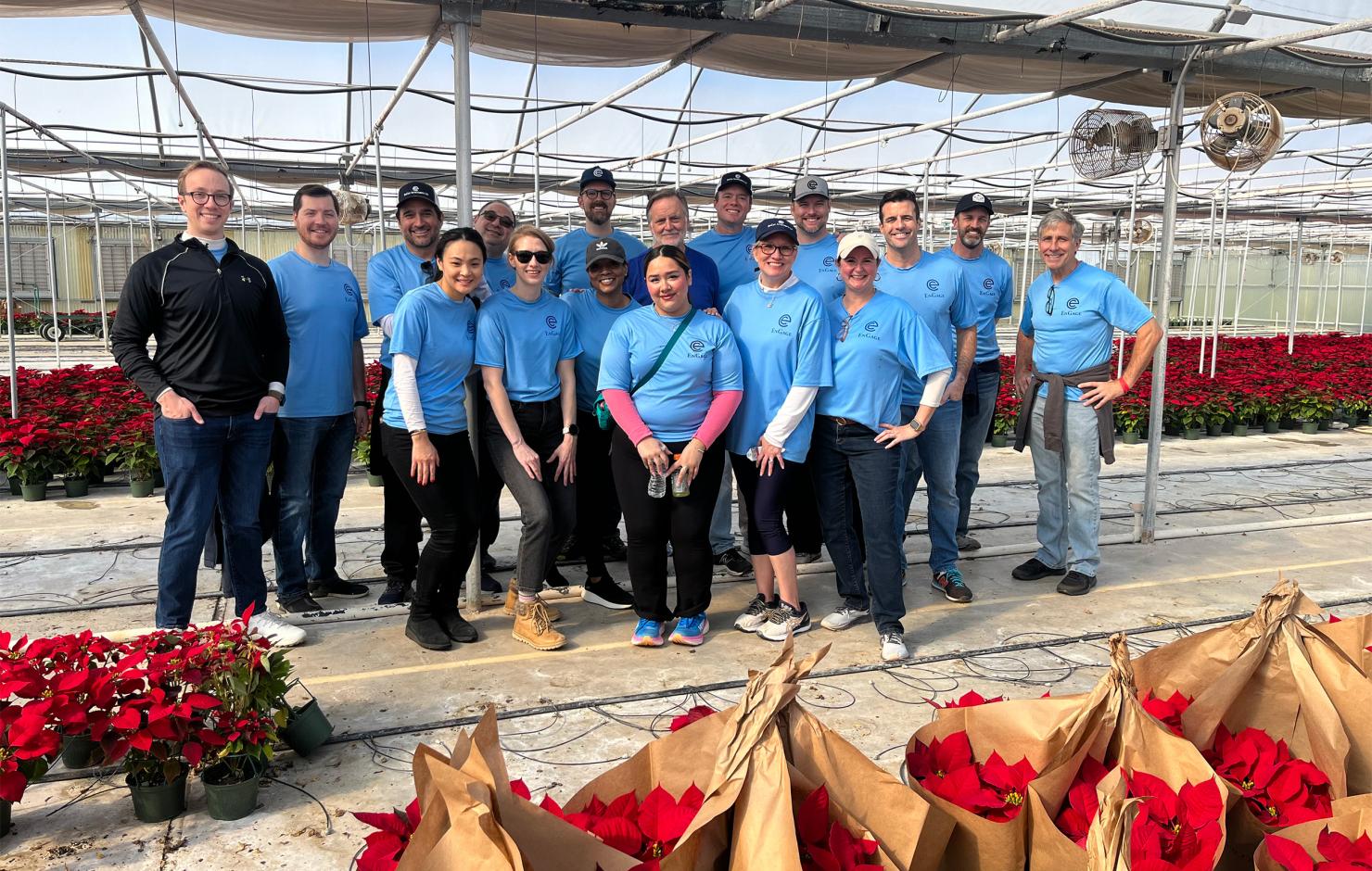  The Gold Team pose for a picture after sleeving and organizing poinsettias. 