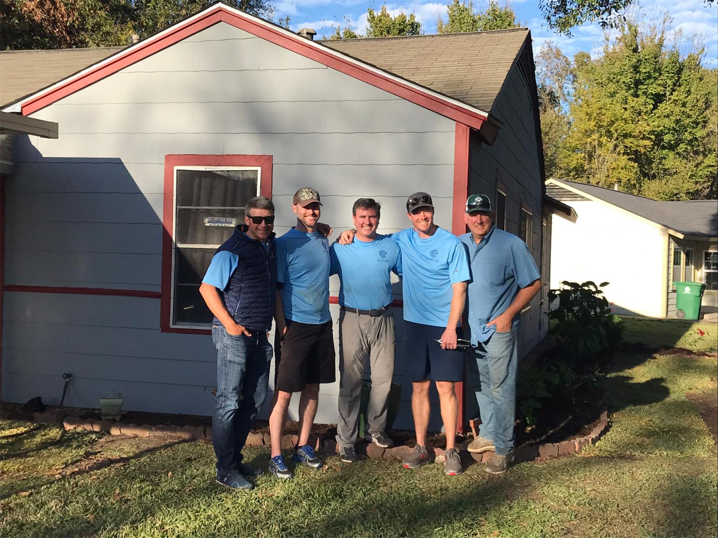 Kyle Kafka, Cole Sanches, Mark Burroughs, Ryan Devlin and Doug Swanson pose for a picture with newly refurbished home.